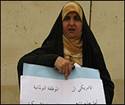 Farah al-Jaberi holds protest sign
